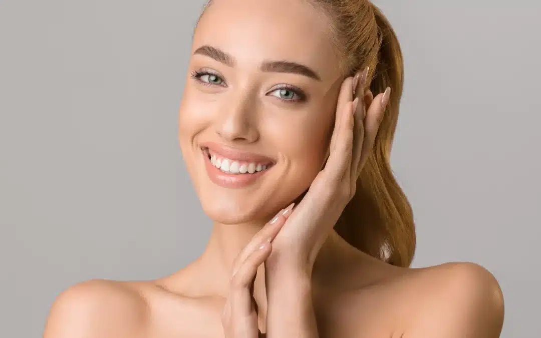 beautiful smiling woman touching her face