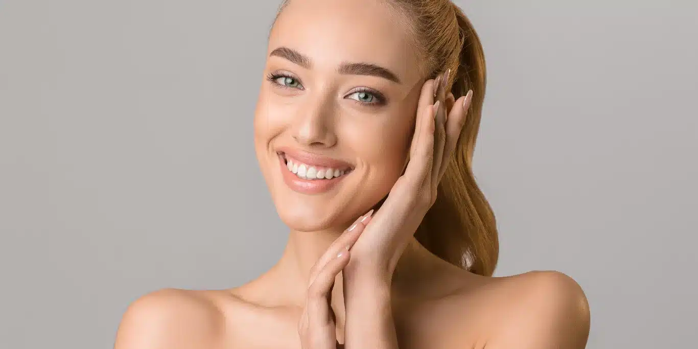 beautiful smiling woman touching her face